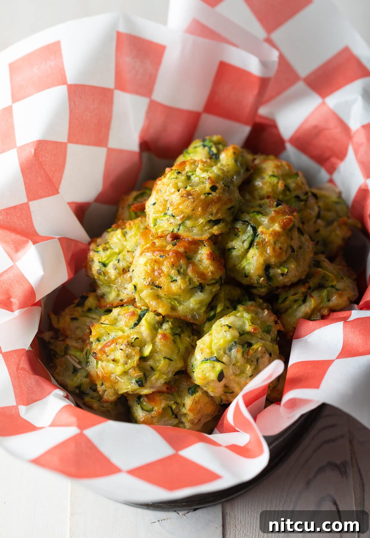 Crispy, golden baked zucchini tots served in a rustic basket, ready to be enjoyed.