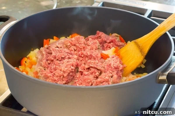 Step 2: Adding tomato products to the One-Pot Sloppy Joe Noodle Skillet