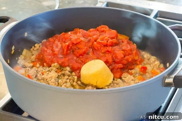 Step 3: Stirring the Sloppy Joe sauce in the skillet