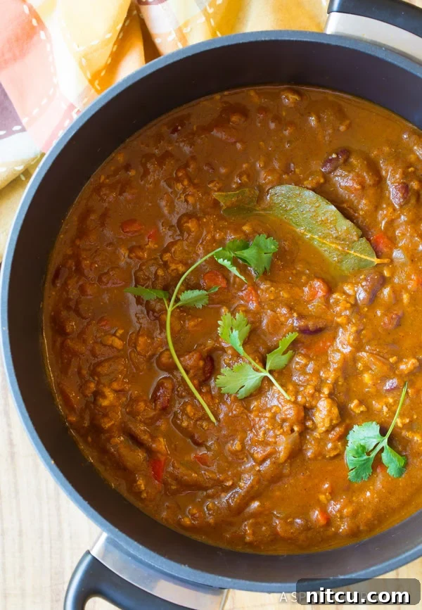 Overhead view of pumpkin chili in a large pot. 