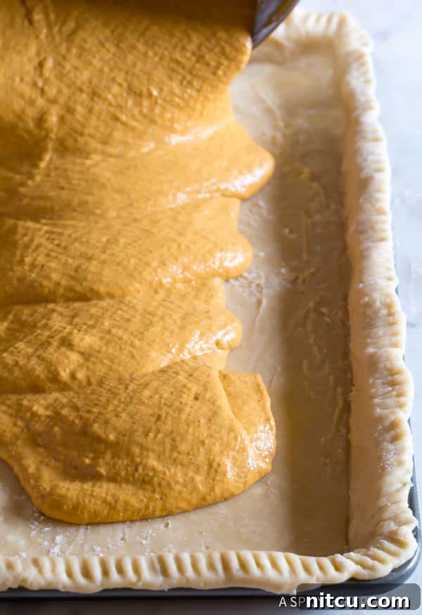 Ingredients for Pumpkin Pie Bars - filling in pan before baking, showing its rich, smooth texture.
