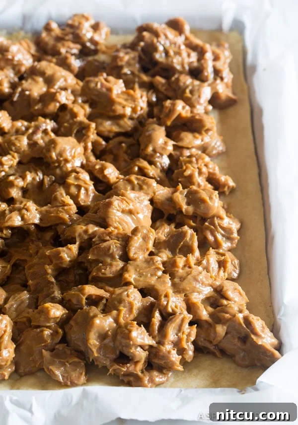 Close-up of the cookie pie base with the rich caramel pecan mixture evenly spread on top, before final baking.