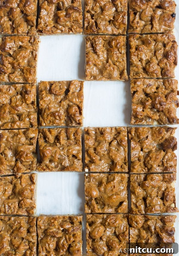An overhead shot of decadent pecan pie dessert bars arranged artfully.