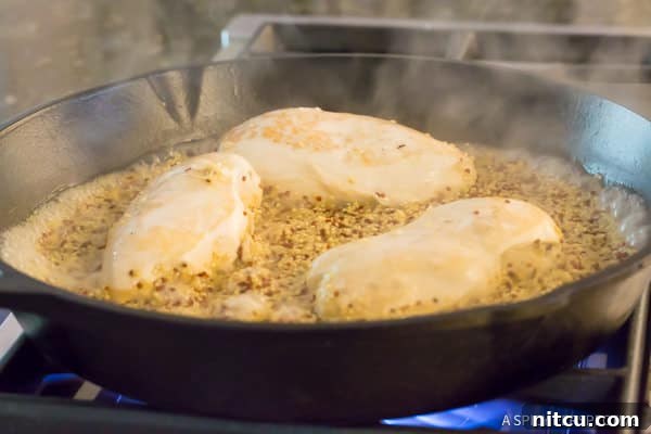 Make this Healthy One-Pot Quinoa with chicken breasts cooking directly in the quinoa and broth mixture, ensuring maximum flavor infusion and tender results.