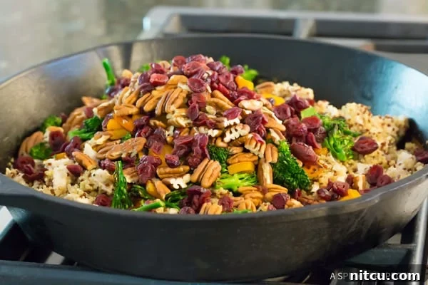 One-Pot Chicken Broccoli recipe with quinoa and nuts, showcasing the delicious blend of ingredients just before serving, highlighting its wholesome and hearty nature.
