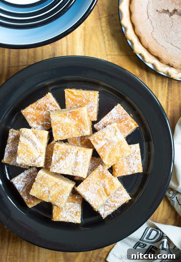 Overhead shot of Ooey Gooey Butter Cake slice stacked on a plate.