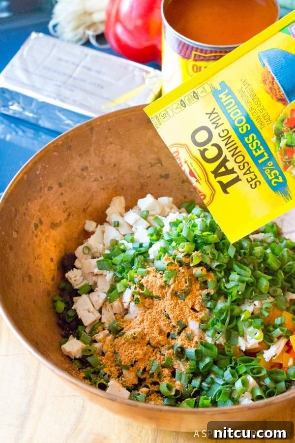 Filling for Southwest Chicken Lasagna Roll Ups in a mixing bowl, ready to be spread on noodles.