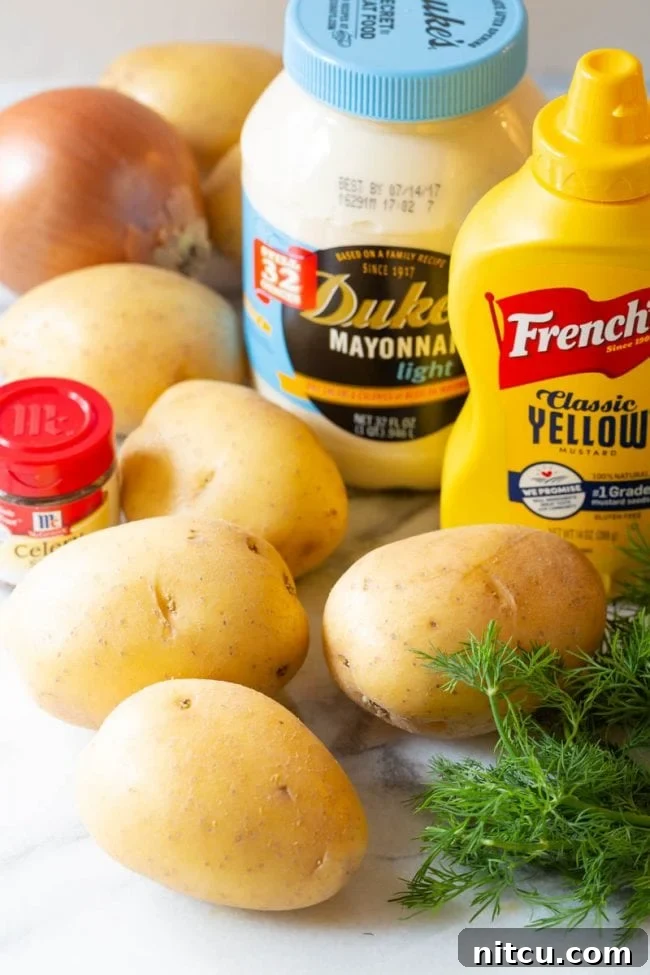 A flat lay photograph showcasing all the fresh ingredients laid out on a counter, ready for making potato salad.