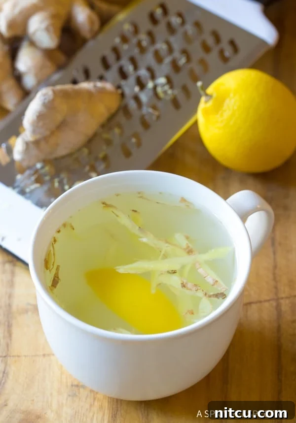 A beautifully presented cup of Lemon Ginger Tea, inviting and warm.