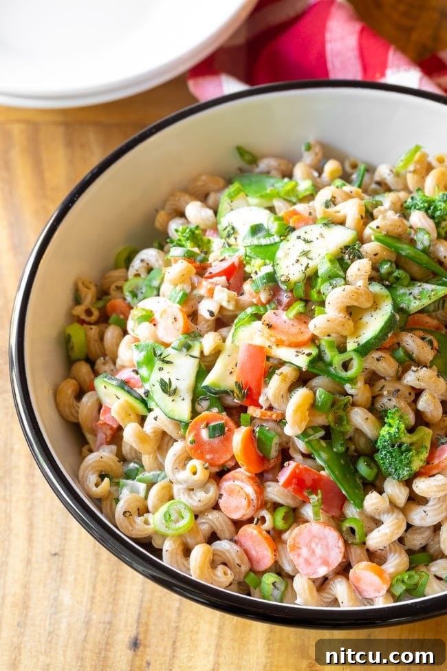 A wide serving bowl generously filled with vibrant veggie pasta, ready to be enjoyed.