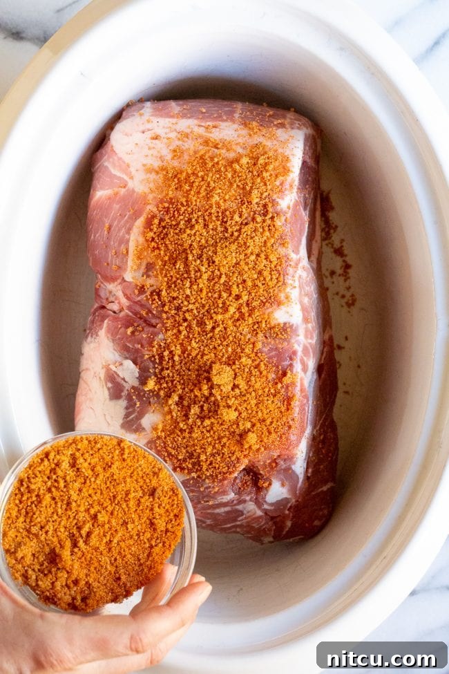 Hand seasoning pork. 