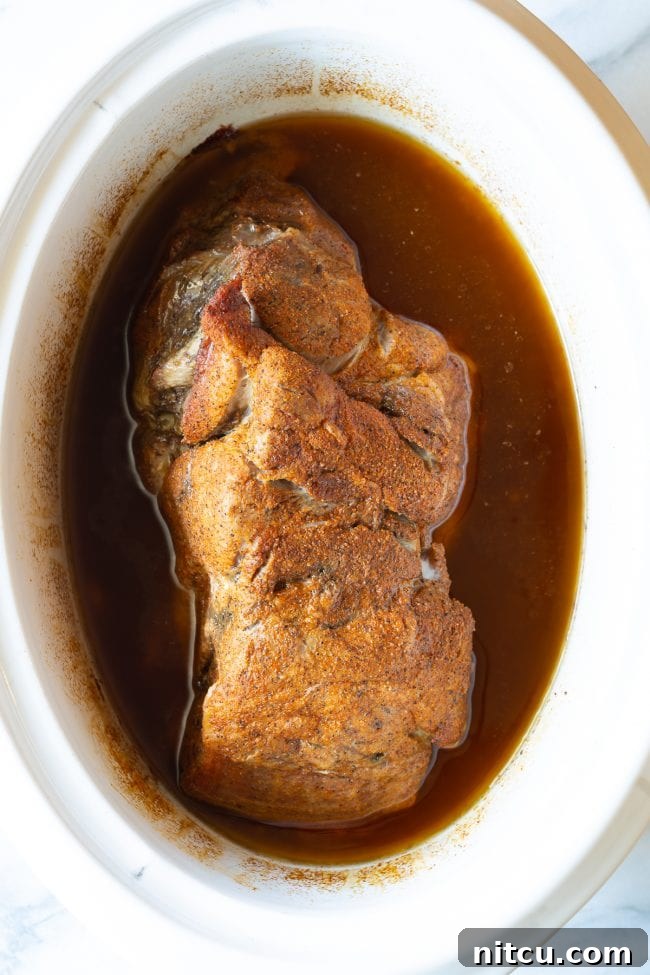 Cooked pork in a crock pot. 