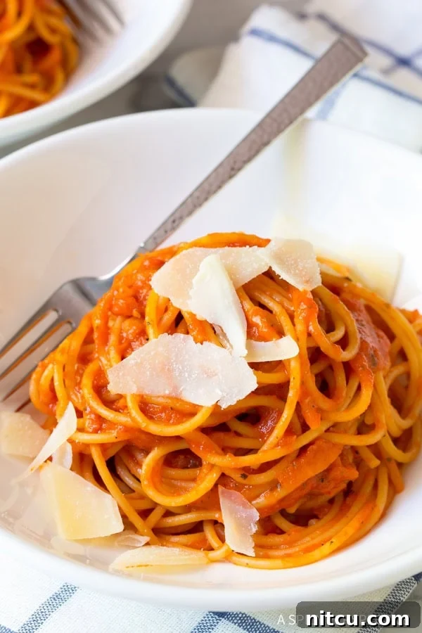 Roasted red pepper pasta with shaved parmesan on top. 
