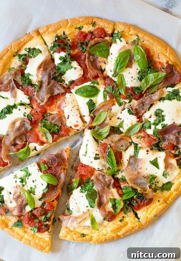 Overhead shot of low carb cloud bread pizza with mozzarella and prosciutto.