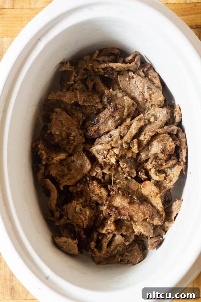Beef for stroganoff in slow cooker crock