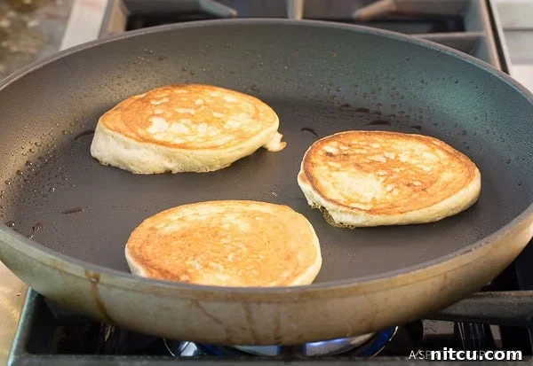 Golden brown pancakes in a skillet. 