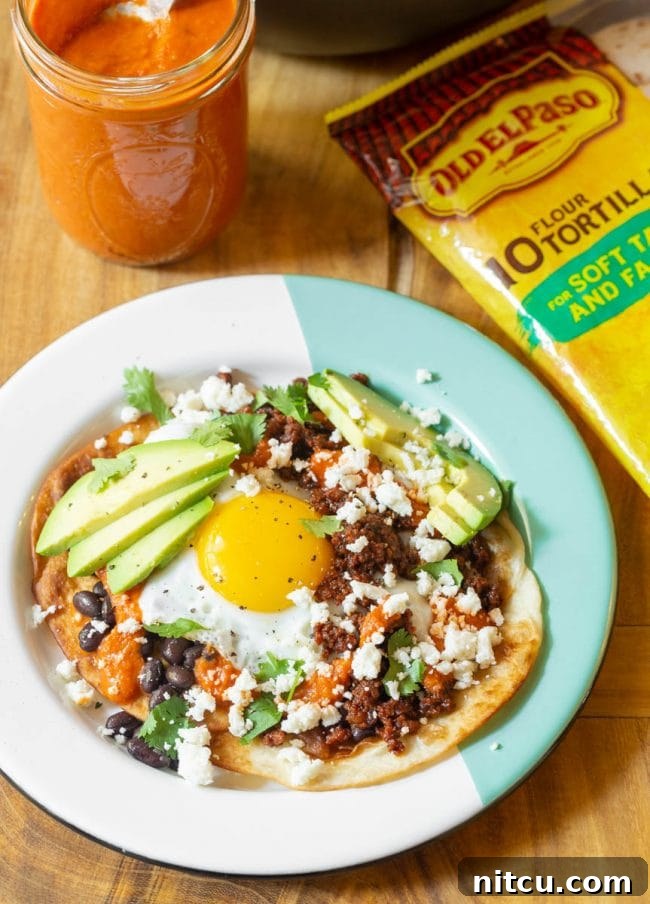 Ingredients for Huevos Rancheros laid out on a table, including tortillas, eggs, and chorizo.