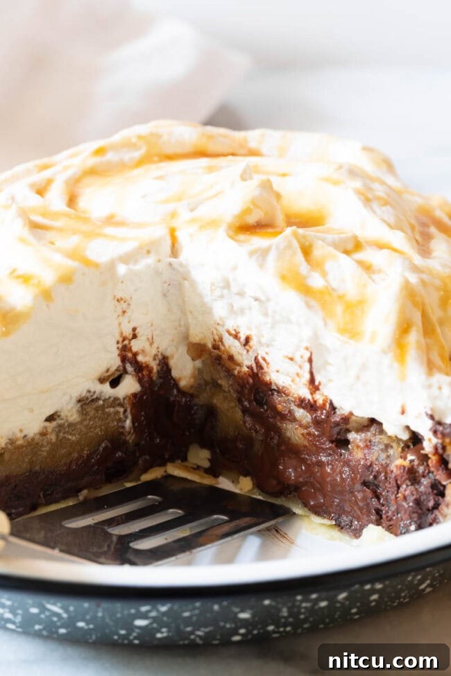 A close-up view of a slice of chocolate pecan pie, showcasing its rich, gooey filling and perfect crust.