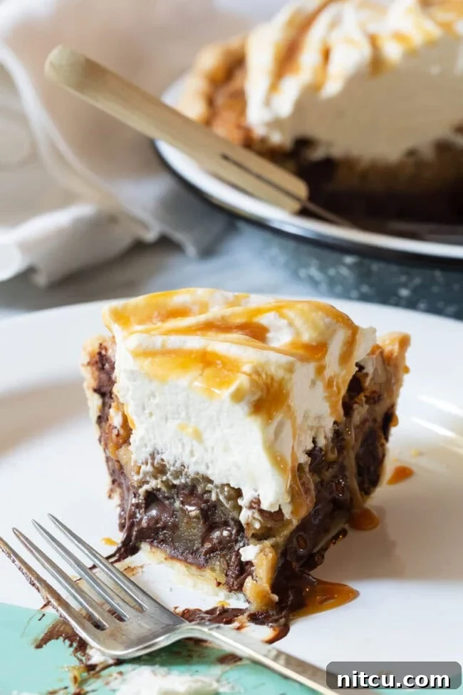 A whole Kentucky Derby Pie with bourbon, artfully presented, ready for slicing.