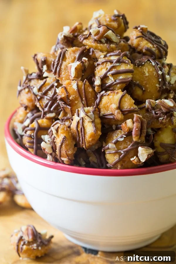 Bowl filled with bits of Christmas crack candy, showcasing its rich texture and chocolate drizzle.