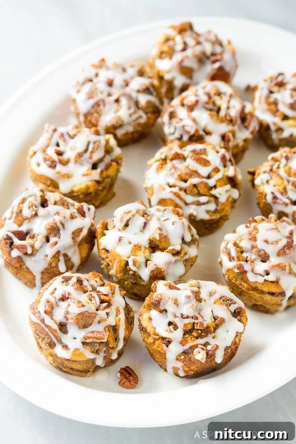 Finished Cinnamon Roll Bread Pudding Muffins drizzled with glaze
