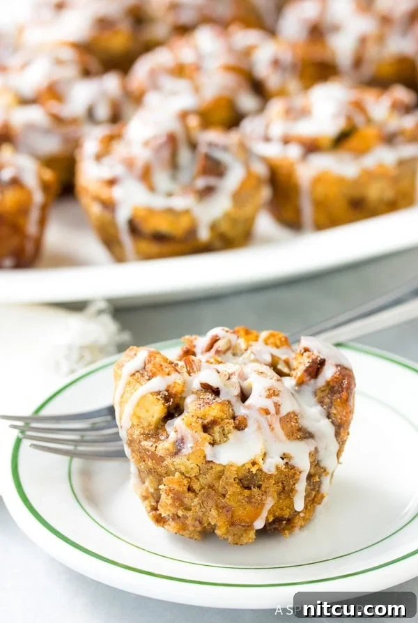 Perfectly baked Cinnamon Roll Bread Pudding Muffins with glaze