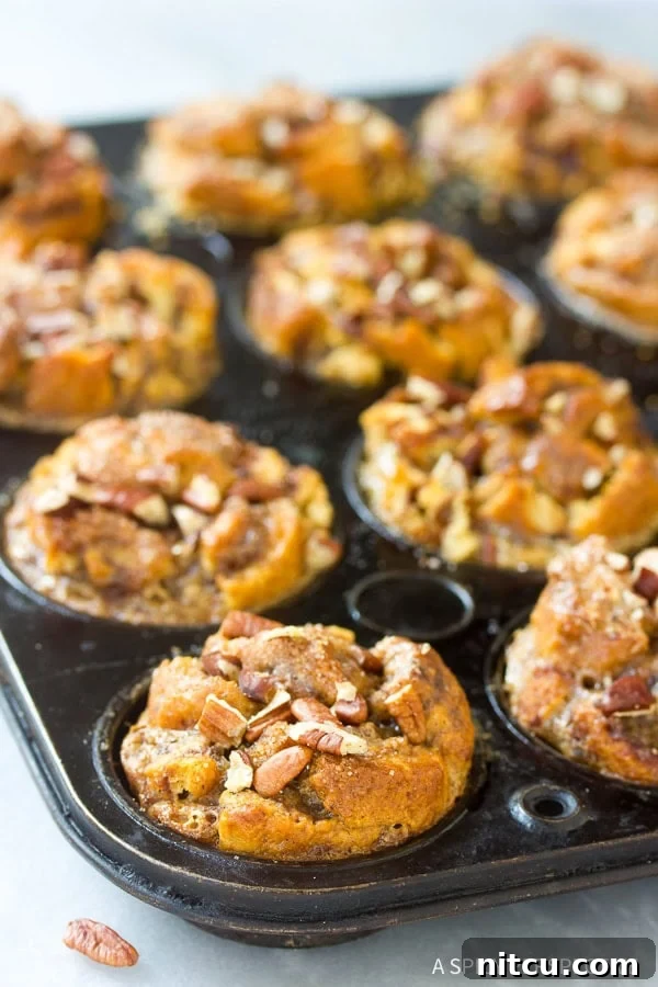 Warm Cinnamon Roll Bread Pudding Muffins cooling on a wire rack