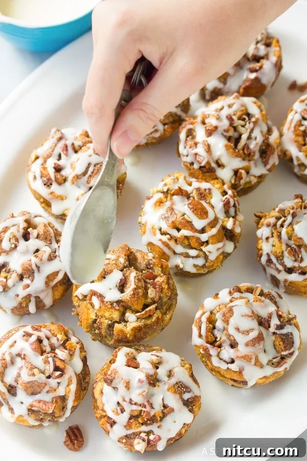 Sprinkling cinnamon sugar on Cinnamon Roll Bread Pudding Muffins before baking