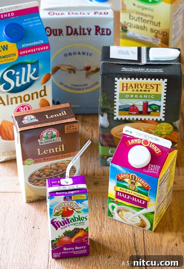 An assortment of food and drink cartons displayed on a rustic wooden background, highlighting the versatility and convenience of modern packaging.