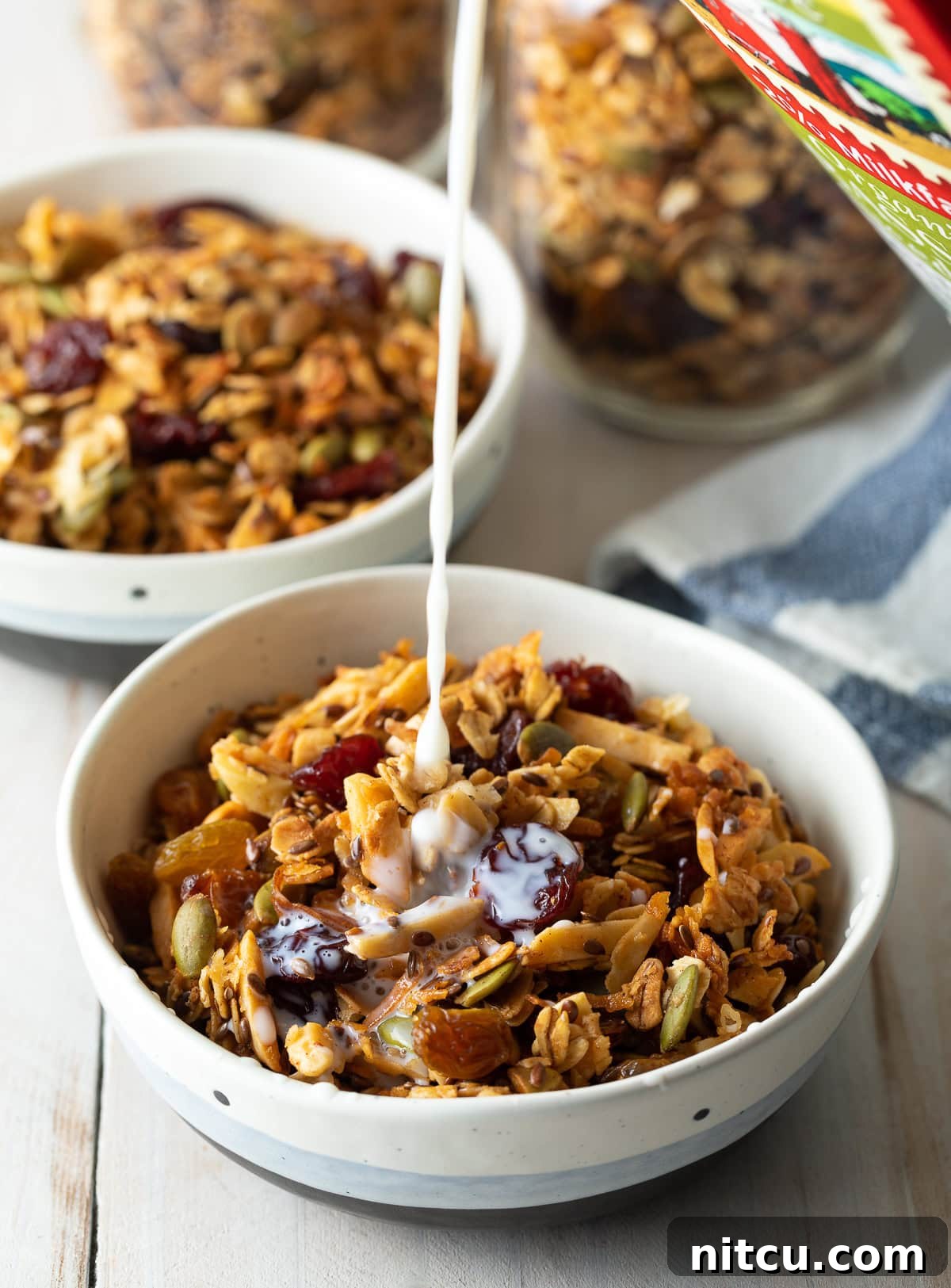 A serving of healthy homemade granola with fresh milk poured over, reminiscent of classic cereal.