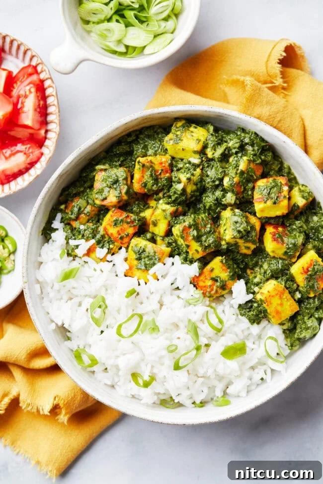 Top down view of Spinach Saag Paneer Recipe in bowl with cheese.