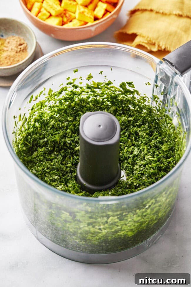 Finely chopped spinach in a food processor.