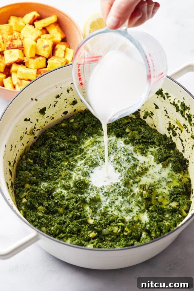 Cream being added to saag paneer mixture.