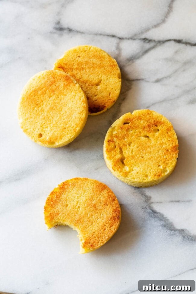 4 slices of low carb microwave mug bread on a marble background. One slice of bread has a bite taken out.