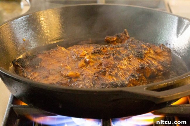 A close-up of the smooth and vibrant Carne Asada marinade mixture.