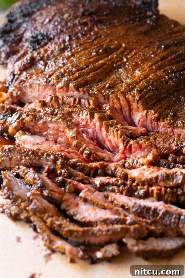 Delicious Carne Asada slices served with fresh pico de gallo and lime, ready to be enjoyed.