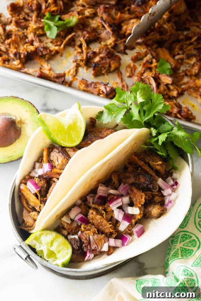 Zesty Instant Pot Carnitas wrapped in warm tortillas, ready to be served as delicious pork tacos