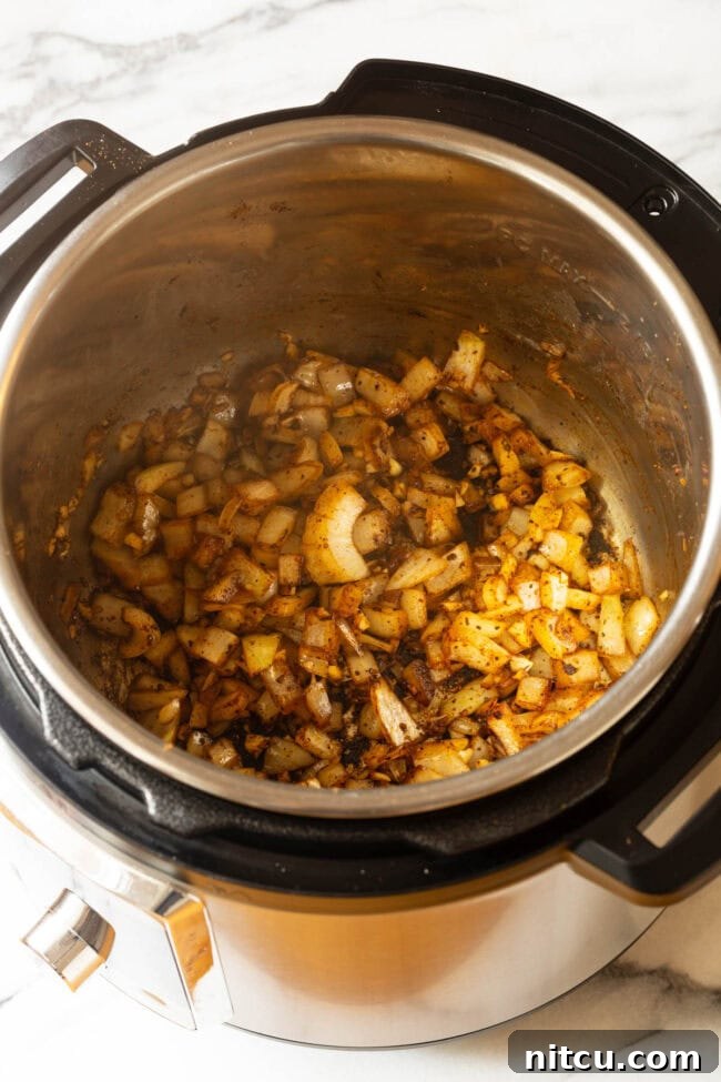 Chopped onion being added to the Instant Pot