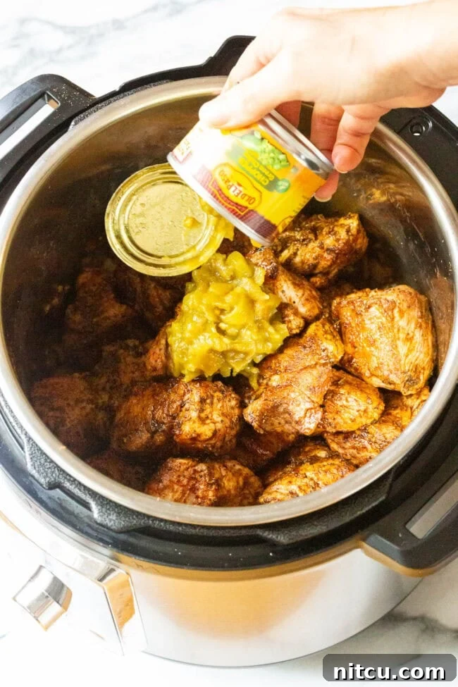 Green chiles and other ingredients simmering in the Instant Pot