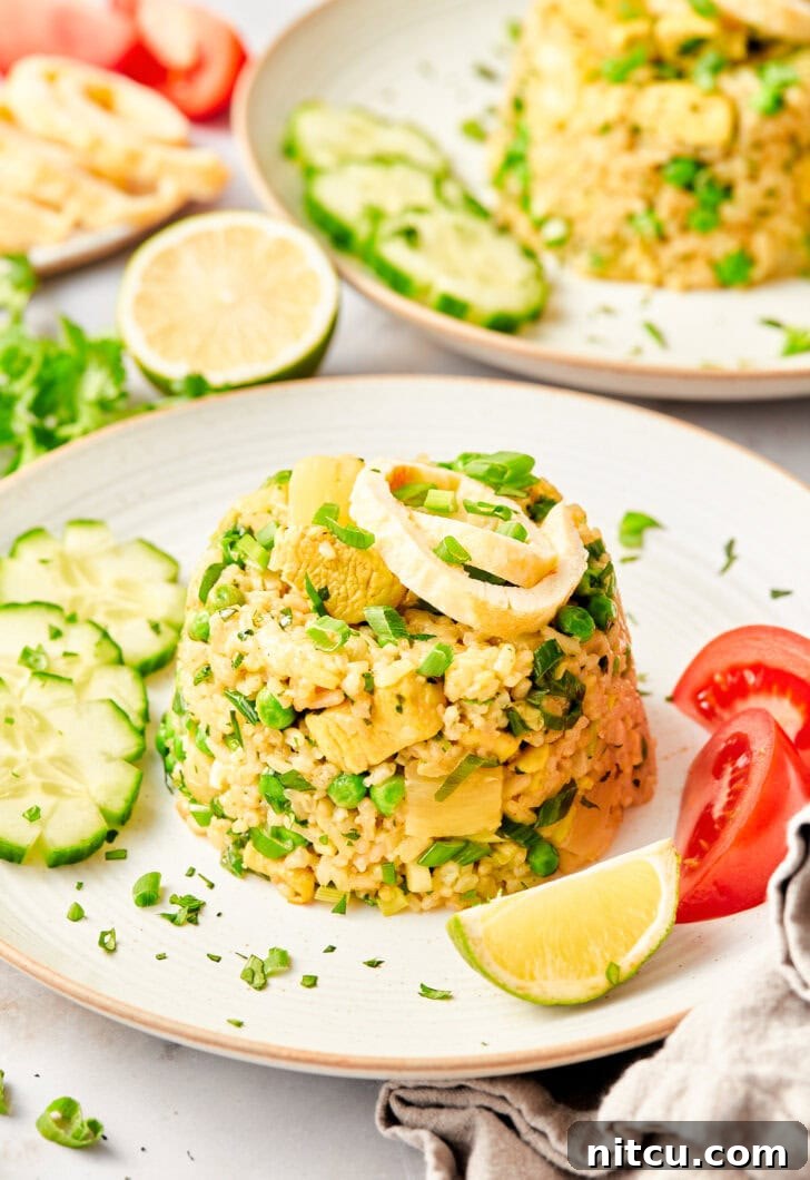 Close-up shot of vibrant Thai fried rice, generously topped with fresh green onions, showcasing its colorful ingredients.