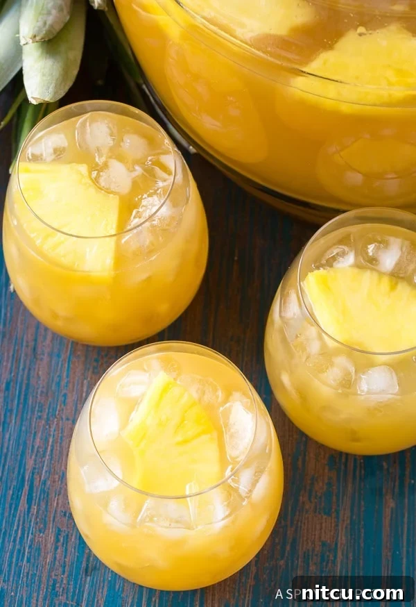 Vibrant Goombay Smash Caribbean Cocktail served in glasses on a decorative tray, perfect for a festive gathering