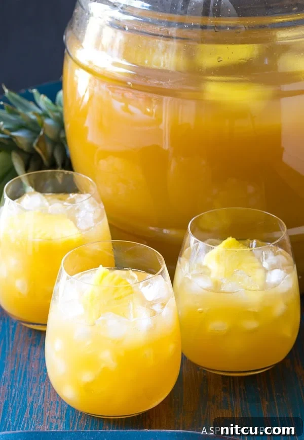 A large batch of Goombay Punch, also known as Goombay Smash, ready for a group gathering, highlighting its vibrant tropical appeal