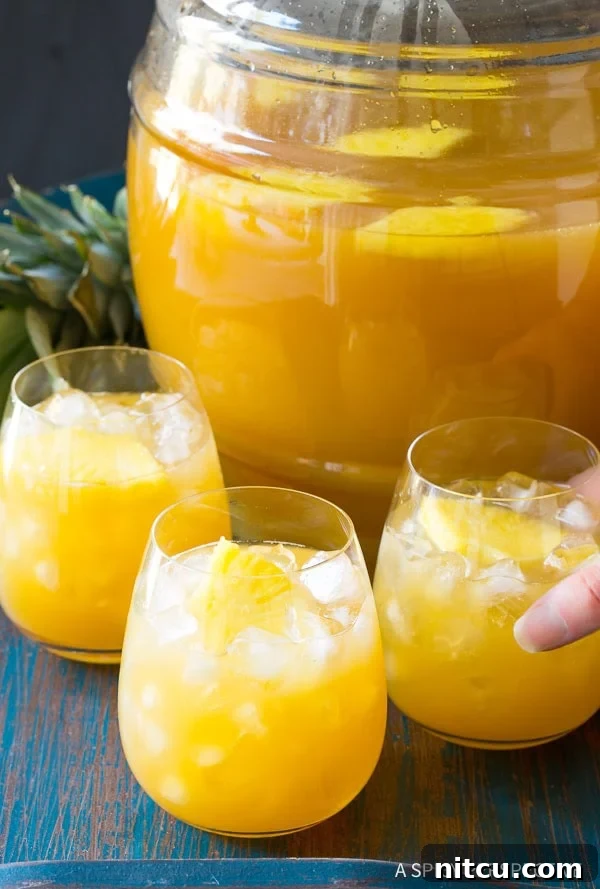 Dazzling large-batch Goombay Smash cocktails served in elegant glasses, ready for a party