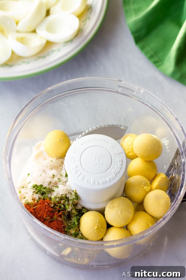 Deviled Eggs ingredients in the food processor for a creamy filling