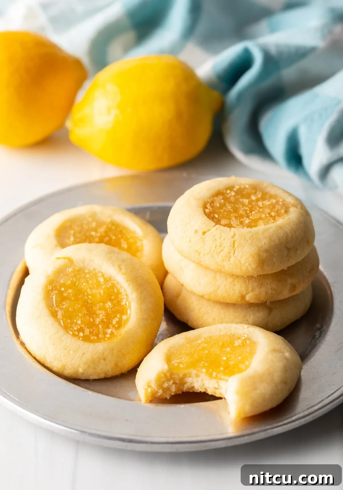 Handful of lemon cookies laid out on a charger perfectly baked