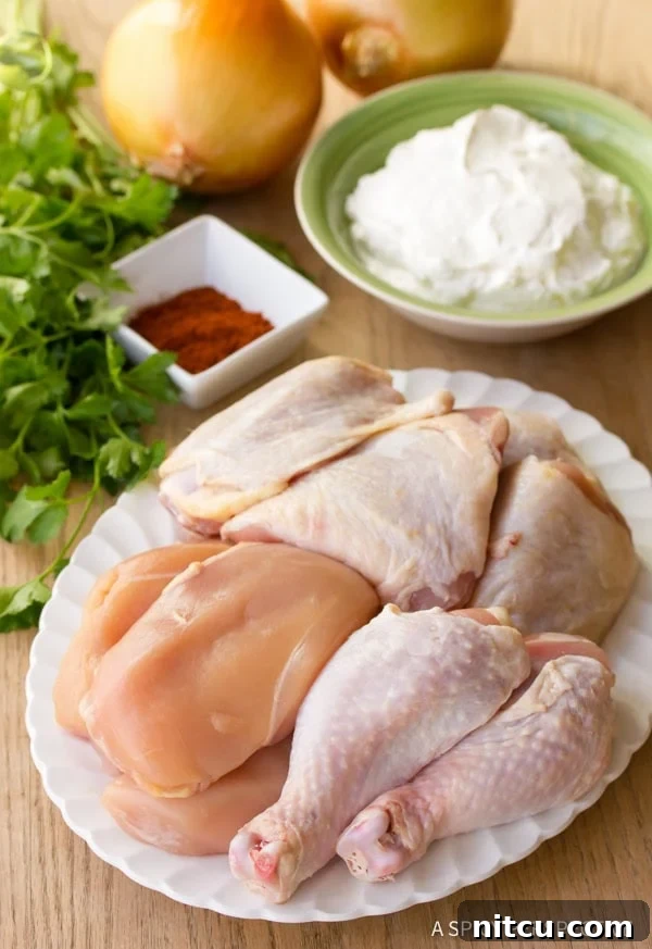 Ingredients for Hungarian Chicken Paprikash, including fresh vegetables and bone-in chicken pieces