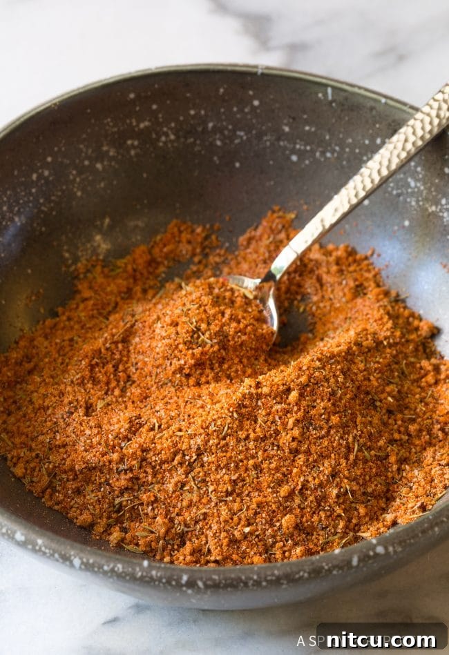 Steak seasoning in a small bowl with a little spoon, ready for use.