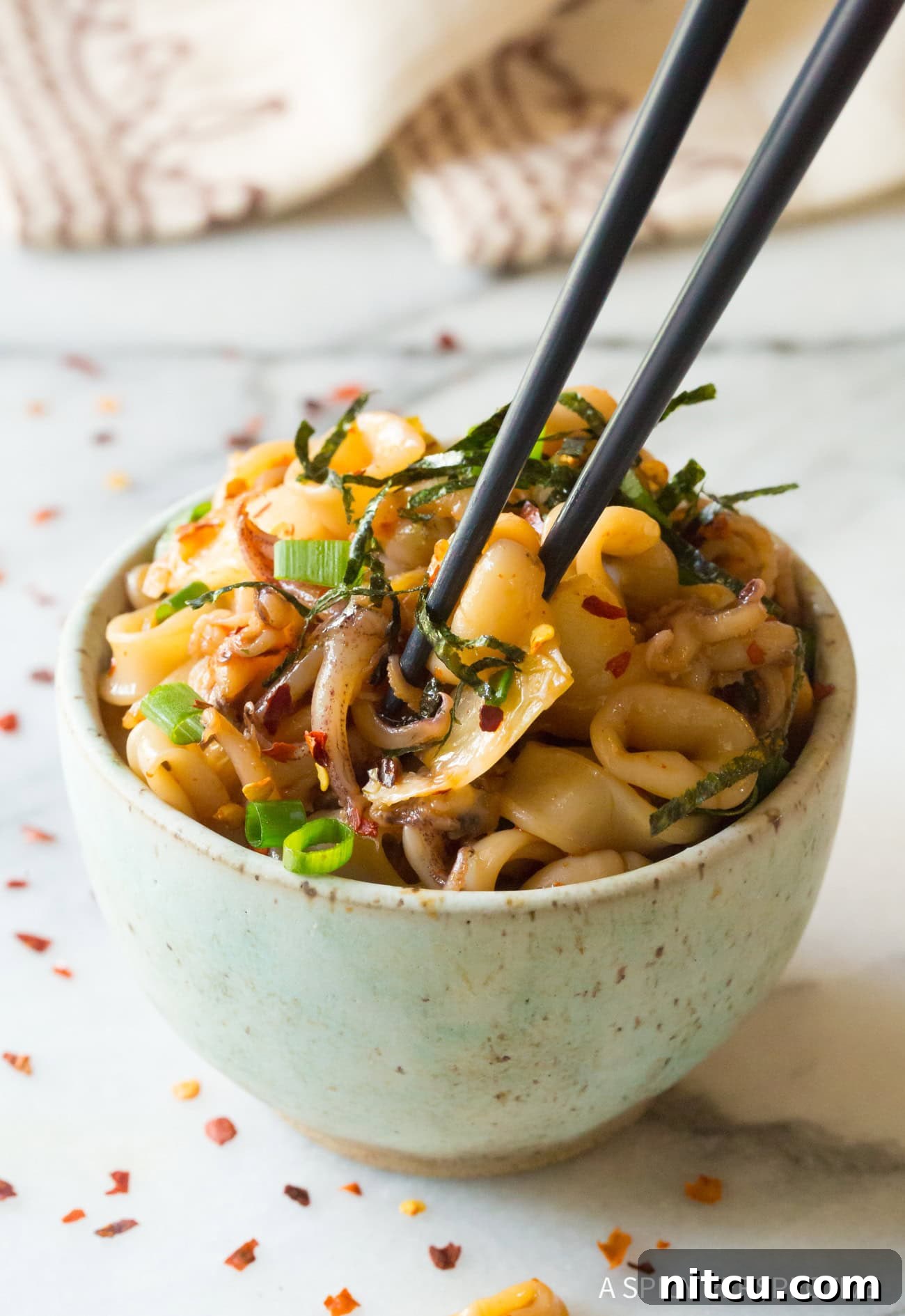 Tako Poke Recipe with octopus in bowl with chopsticks