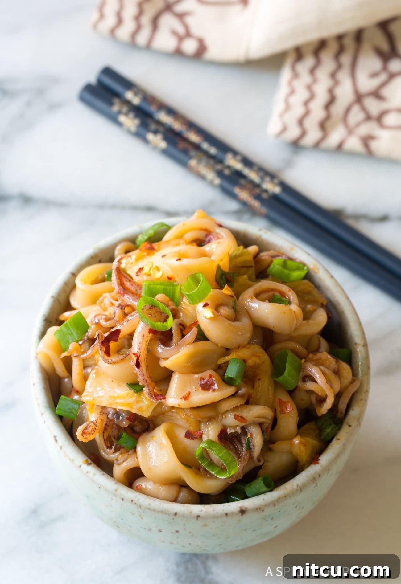 Tako Poke (Octopus or Squid) overhead shot in bowl with scallions on top