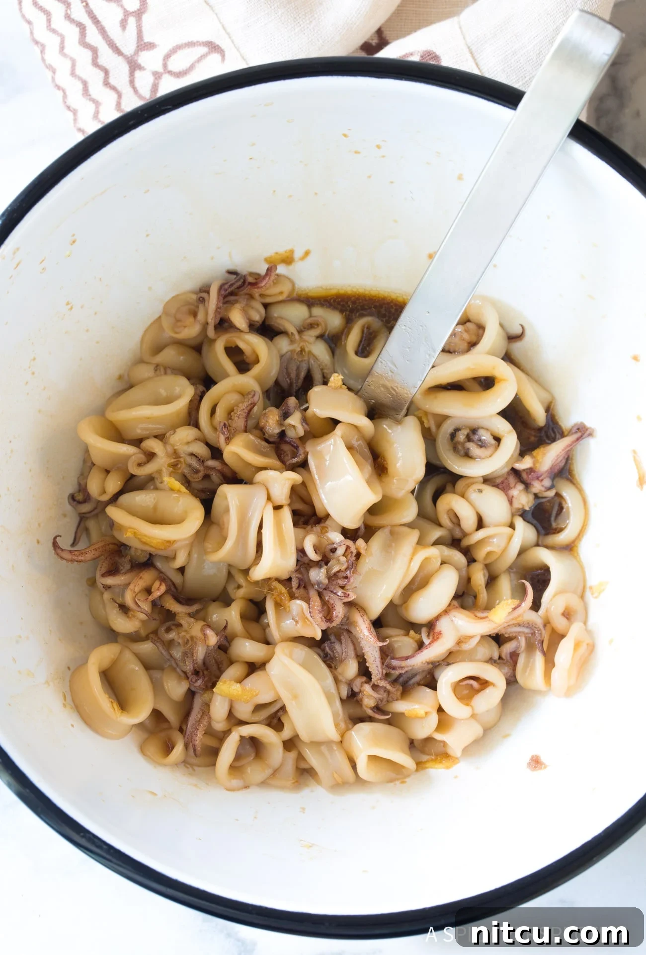 Making Hawaiian Poke Recipe - marinating squid in bowl